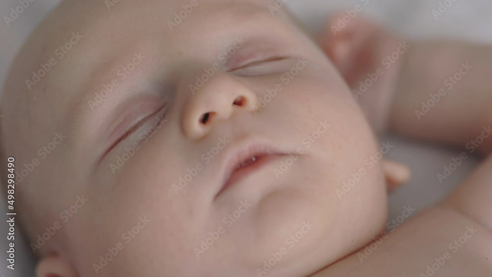 Close up of adorable baby boy sleeping naked in bed Close up of adorable baby boy sleeping naked in bed