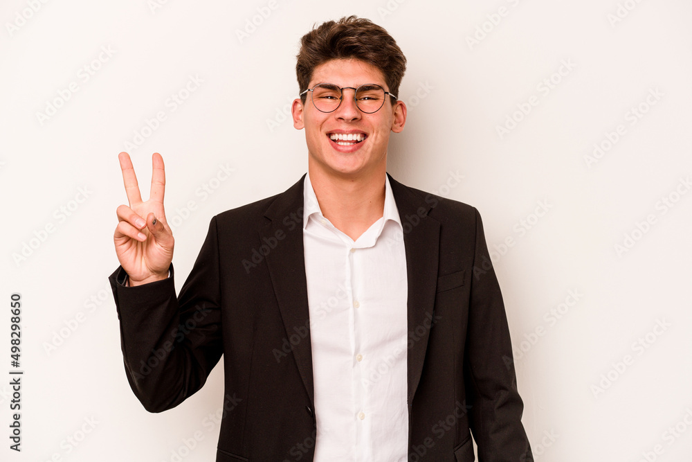 Young caucasian business man isolated on white background joyful and carefree showing a peace symbol with fingers. Young caucasian business man isolated on white background joyful and carefree showing a peace symbol with fingers.
