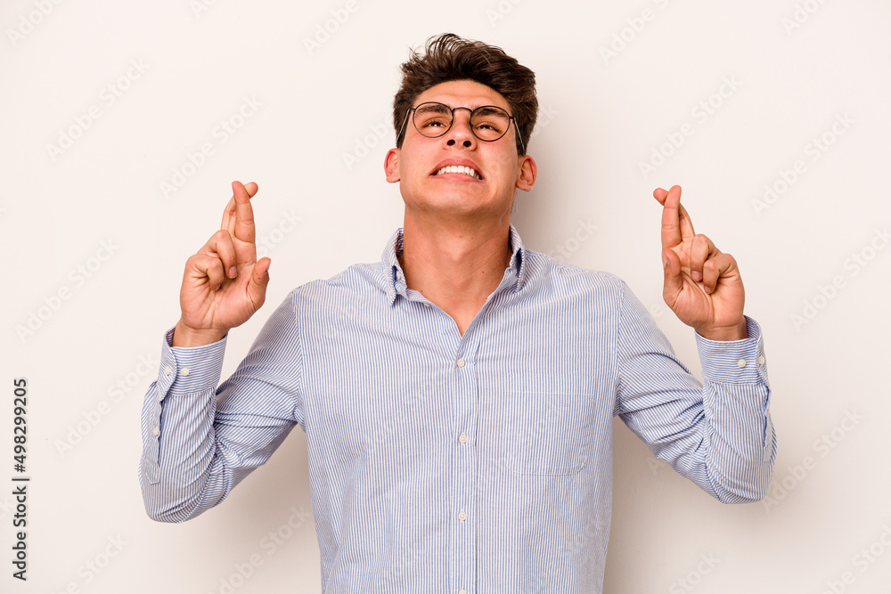 Young caucasian man isolated on white background crossing fingers for having luck Young caucasian man isolated on white background crossing fingers for having luck