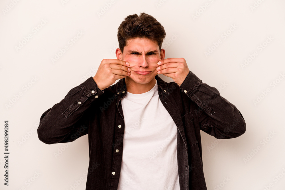 Young caucasian man isolated on white background doubting between two options. Young caucasian man isolated on white background doubting between two options.