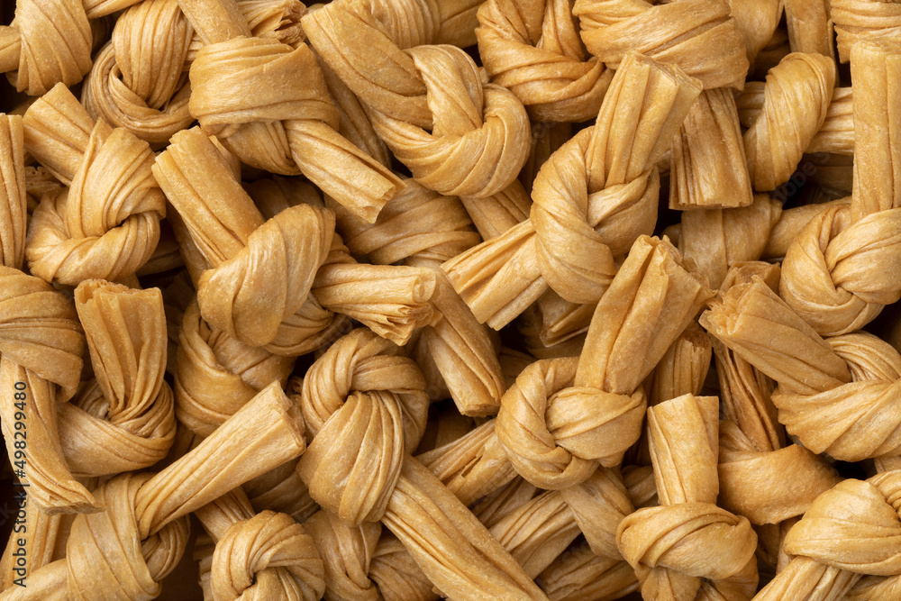 Uncooked bean curd knot full frame close up as background Uncooked bean curd knot full frame close up as background