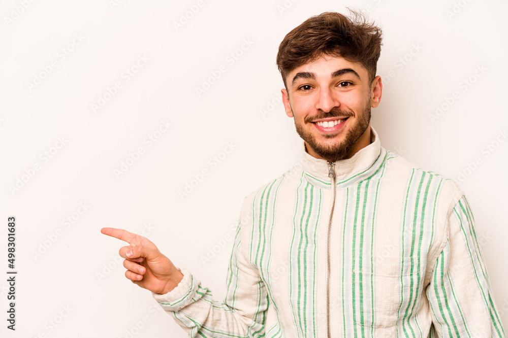 Young hispanic man isolated on white background smiling cheerfully pointing with forefinger away. Young hispanic man isolated on white background smiling cheerfully pointing with forefinger away.