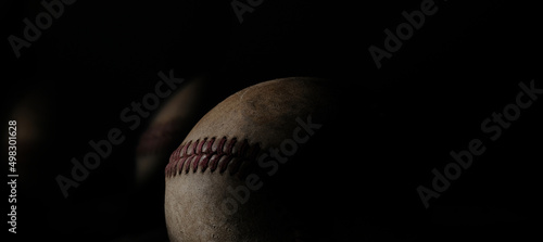 Baseball ball close up with black background for sports concept with copy space.