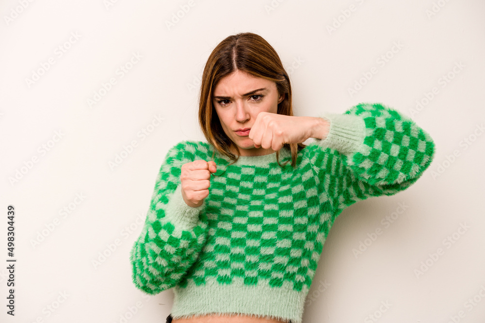 Young caucasian woman isolated on white background throwing a punch, anger, fighting due to an argument, boxing. Young caucasian woman isolated on white background throwing a punch, anger, fighting due to an argument, boxing.