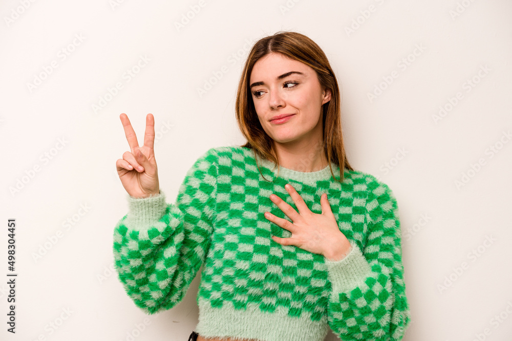 Young caucasian woman isolated on white background taking an oath, putting hand on chest. Young caucasian woman isolated on white background taking an oath, putting hand on chest.