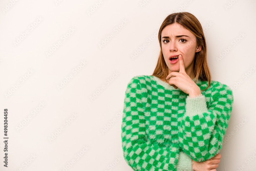Young caucasian woman isolated on white background looking sideways with doubtful and skeptical expression. Young caucasian woman isolated on white background looking sideways with doubtful and skeptical expression.