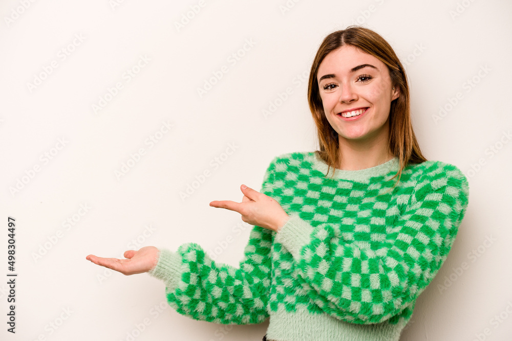 Young caucasian woman isolated on white background excited holding a copy space on palm. Young caucasian woman isolated on white background excited holding a copy space on palm.