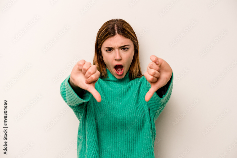 Young caucasian woman isolated on white background showing thumb down and expressing dislike. Young caucasian woman isolated on white background showing thumb down and expressing dislike.