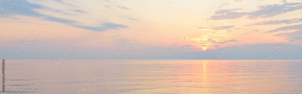 Baltic sea after the rain. Dramatic sunset sky, glowing pink and golden storm clouds. Picturesque panoramic scenery. Nature, environment, fickle weather, cyclone - obrazy, fototapety, plakaty 