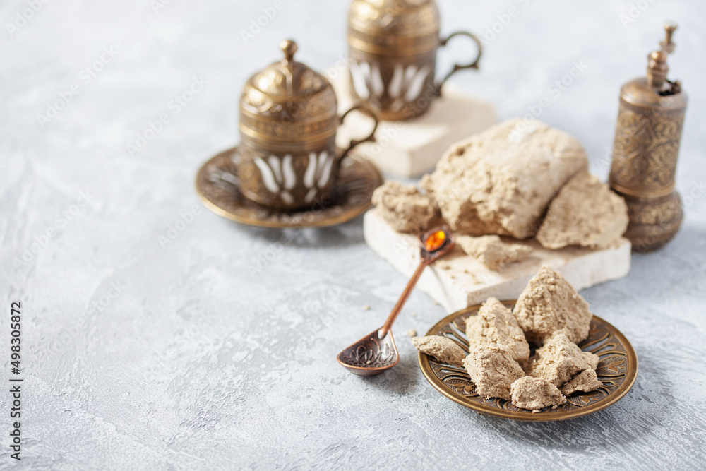 Greek (Turkish) brewed coffee and halva on a table. Oriental sweetness. Copy space Greek (Turkish) brewed coffee and halva on a table. Oriental sweetness. Copy space