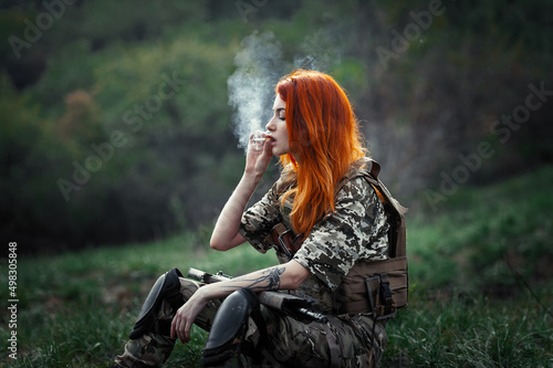 Fototapeta Sniper girl in a green field