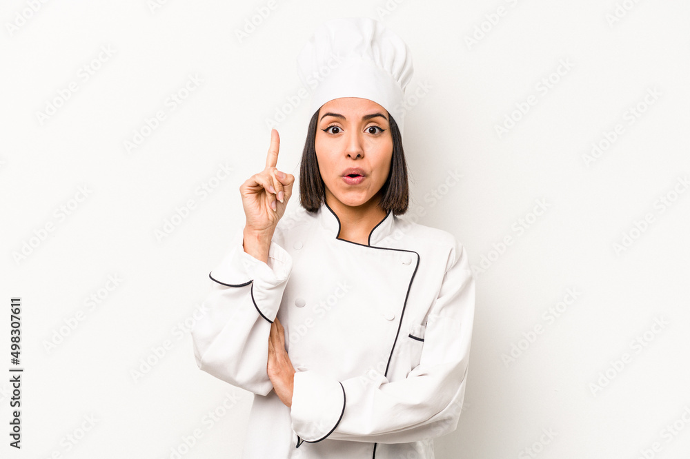 Young hispanic chef woman isolated on white background having some great idea, concept of creativity. Young hispanic chef woman isolated on white background having some great idea, concept of creativity.
