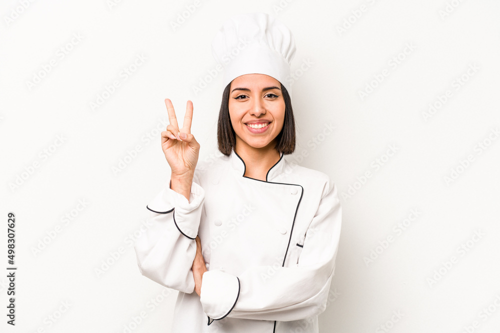 Young hispanic chef woman isolated on white background showing number two with fingers. Young hispanic chef woman isolated on white background showing number two with fingers.