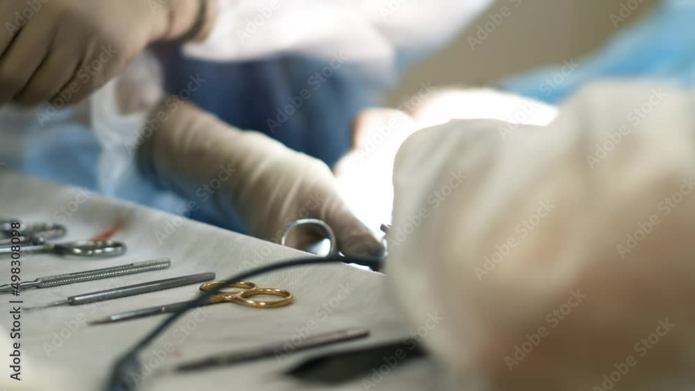 table with surgical instruments in the operating room, the surgeon works with an assistant. table with surgical instruments in the operating room, the surgeon works with an assistant.