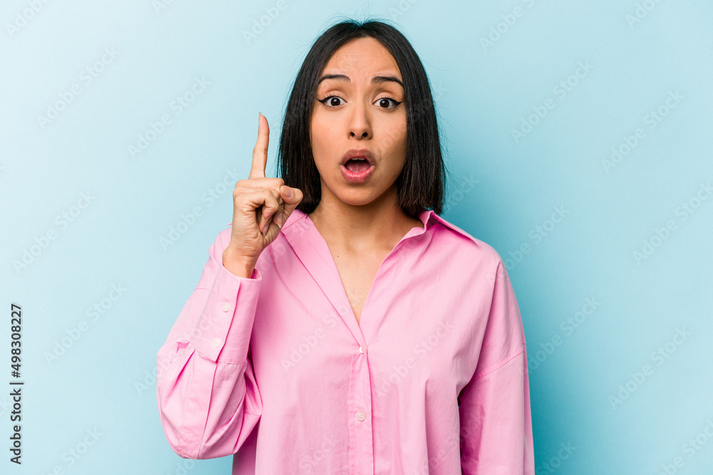 Young hispanic woman isolated on blue background having some great idea, concept of creativity. Young hispanic woman isolated on blue background having some great idea, concept of creativity.