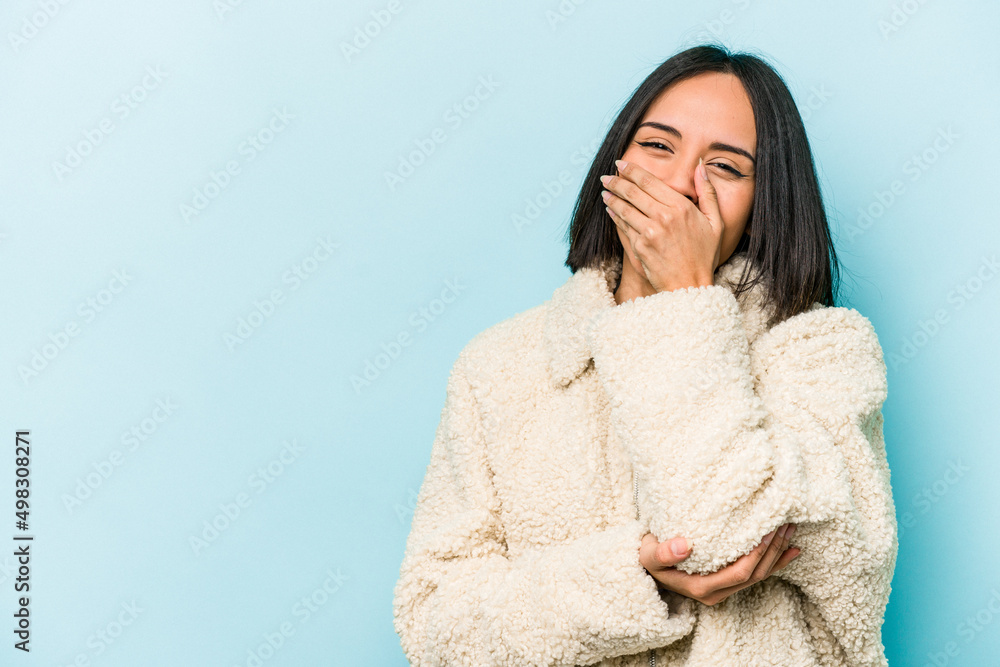 Young hispanic woman isolated on blue background laughing happy, carefree, natural emotion. Young hispanic woman isolated on blue background laughing happy, carefree, natural emotion.