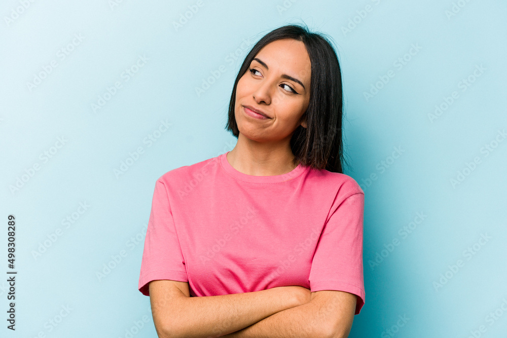 Young hispanic woman isolated on blue background dreaming of achieving goals and purposes Young hispanic woman isolated on blue background dreaming of achieving goals and purposes