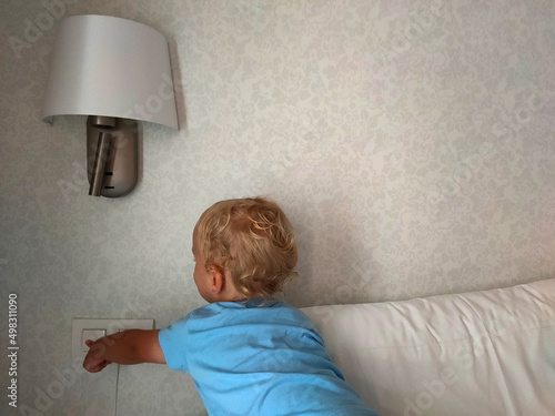 the child puts out the light by pressing the switch
