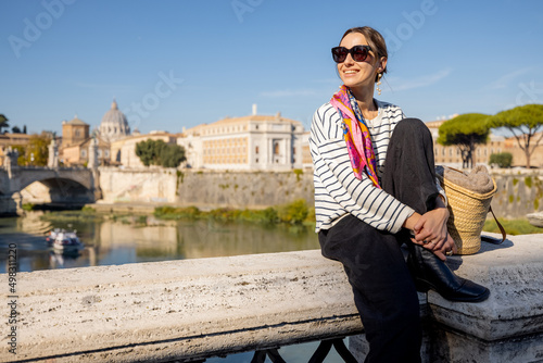 Wall Mural Woman enjoying beautiful view of Rome city and Vatican standing on the bridge on a sunny autumn day