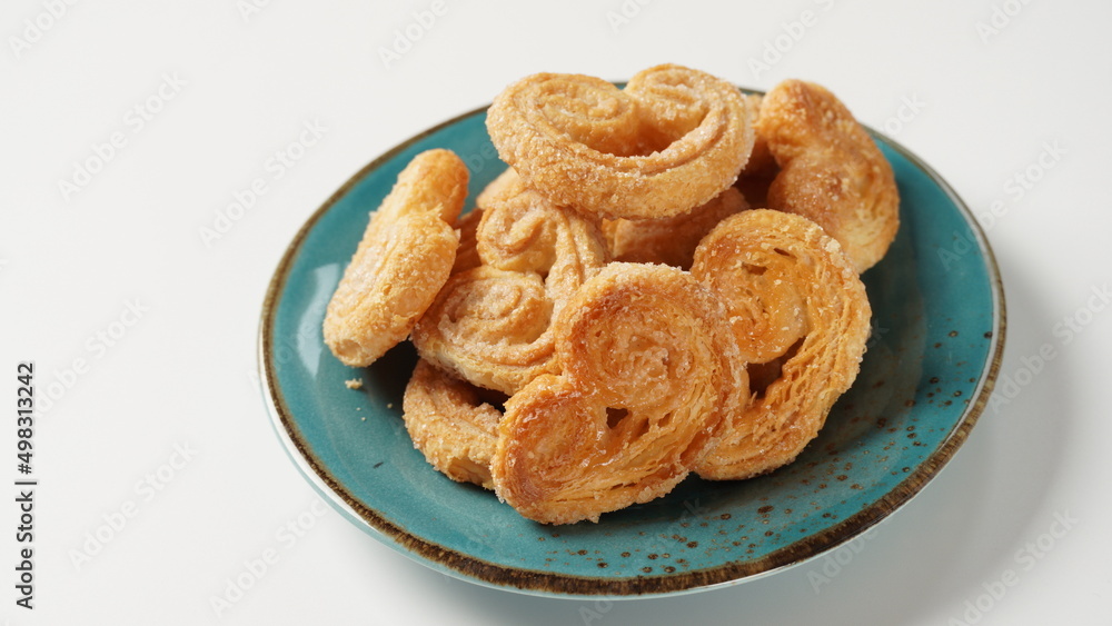 Palmier biscuits - french cookies made of puff pastry also called palm leaves, elephant ears or french hearts Palmier biscuits - french cookies made of puff pastry also called palm leaves, elephant ears or french hearts