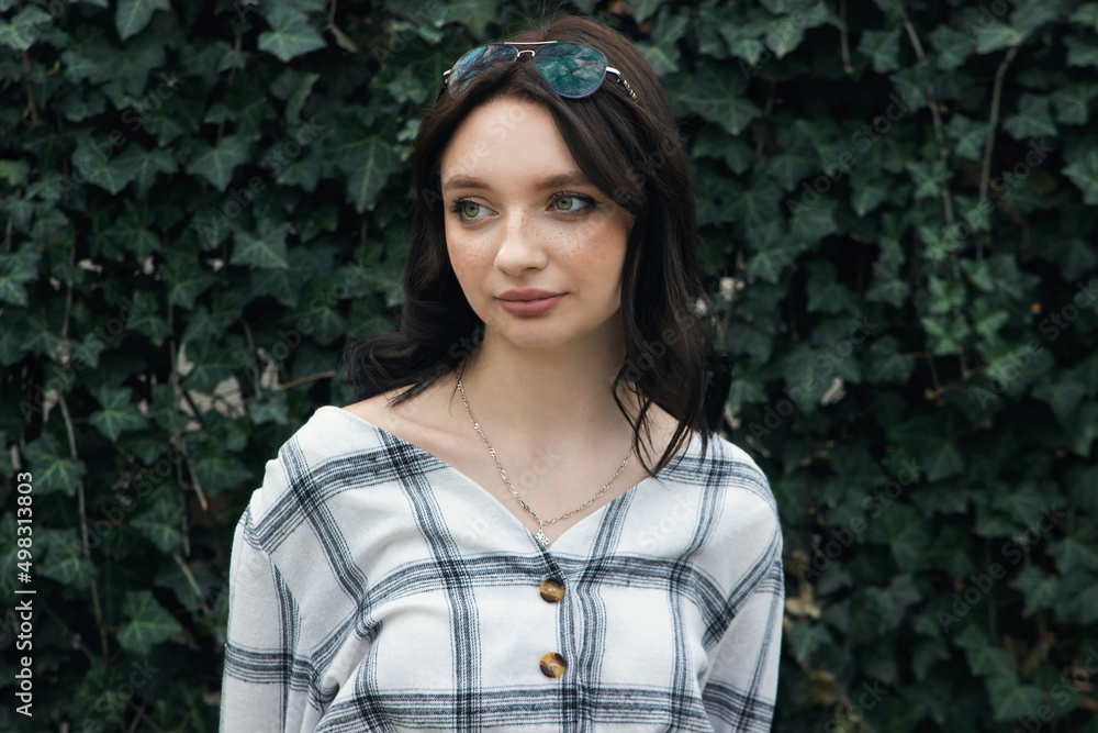 Girl on the background of a green wall. Portrait of a beautiful young girl. Girl on the background of a green wall. Portrait of a beautiful young girl.