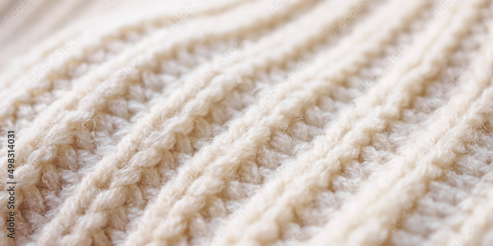 closeup beige knitted woolen fabric texture background closeup beige knitted woolen fabric texture background