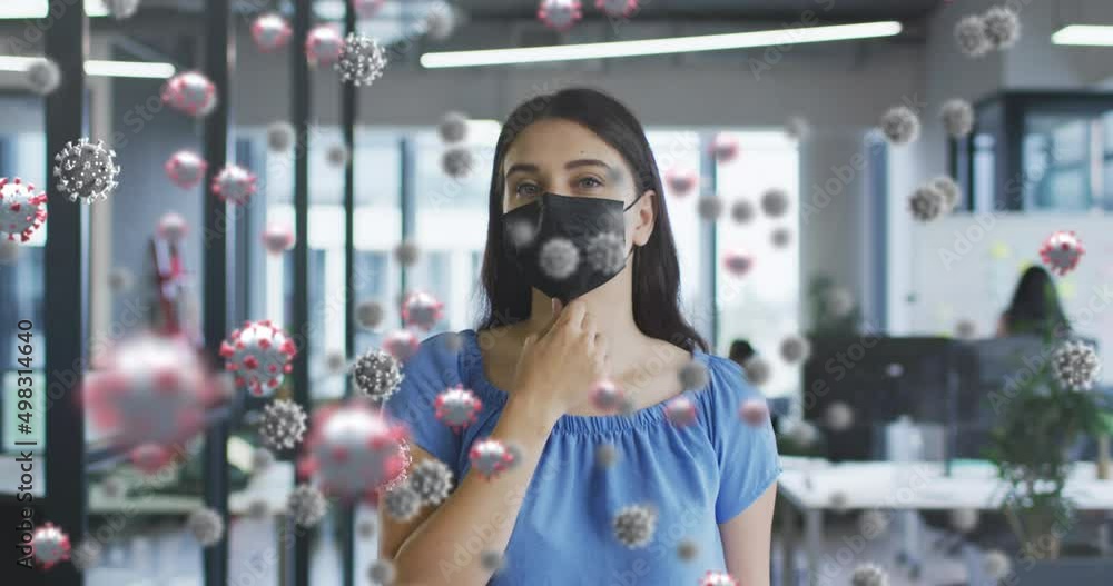 Animation of virus cells over caucasian woman wearing face mask Animation of virus cells over caucasian woman wearing face mask