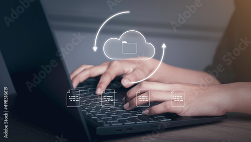 Document Management Data System (DMS) concept. Businessman working with laptop computer with cloud and document icons on virtual screen upload, download.