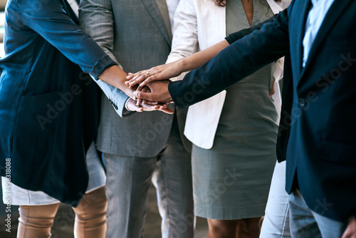 Teamwork can be a companys greatest asset. Cropped shot of a group of unrecognizable businesspeople standing with their hands in a huddle in the office. © Katleho Seisa/peopleimages.com