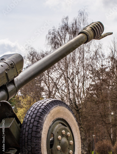 Tank and howitzer stand on the street in Ukraine. In the Kiev park there is a gun and a green tank. photo