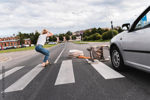 Shocked mother on the crosswalk after car accident when vehicle hits her baby pram