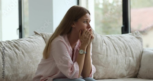 Wallpaper Mural Yearning woman looks hopeless thinks of life troubles sit on sofa at home staring into distance deep in sad thoughts feels desperate. Unwanted pregnancy, hard decision about abortion, break up concept Torontodigital.ca