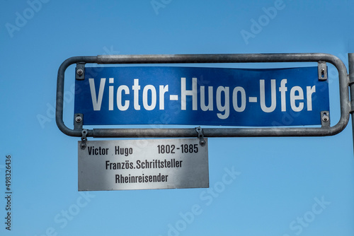 street sign Victor Hugo Ufer - english: Victor Hugo riverbank - under clear blue sky