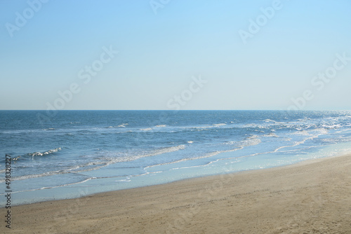 Beautiful view of sea shore and blue sky on sunny day