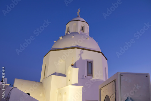 Closeup view of a beautiful whitewashed and traditional orthodox church in Santorini Greece