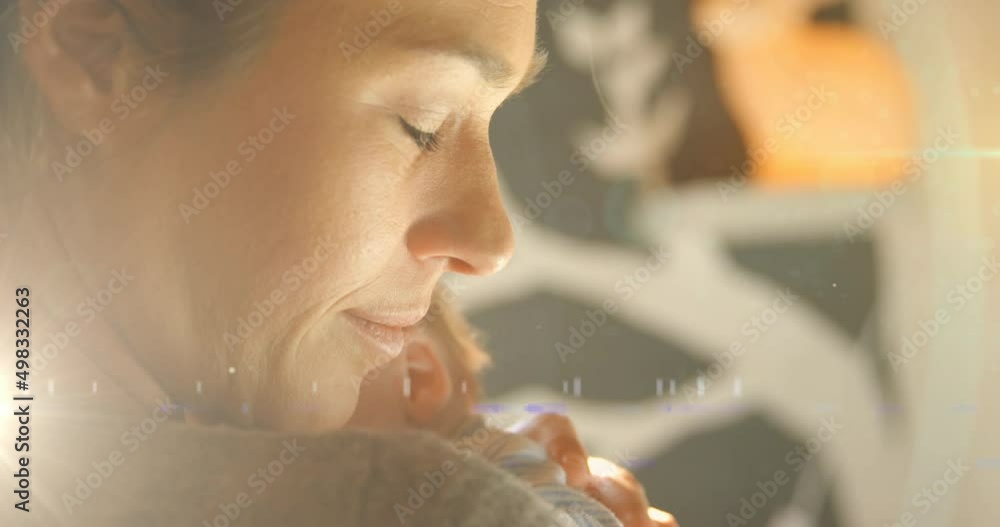 Animation of glowing spots over happy caucasian mother with sleeping baby Animation of glowing spots over happy caucasian mother with sleeping baby