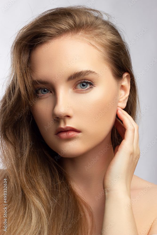 Beautiful woman with bright make up eye with sexy black liner makeup. Fashion big arrow shape on woman's eyelid. Natural lips. Chic evening make-up. Blonde long wave hair. Shining face skin Beautiful woman with bright make up eye with sexy black liner makeup. Fashion big arrow shape on woman's eyelid. Natural lips. Chic evening make-up. Blonde long wave hair. Shining face skin