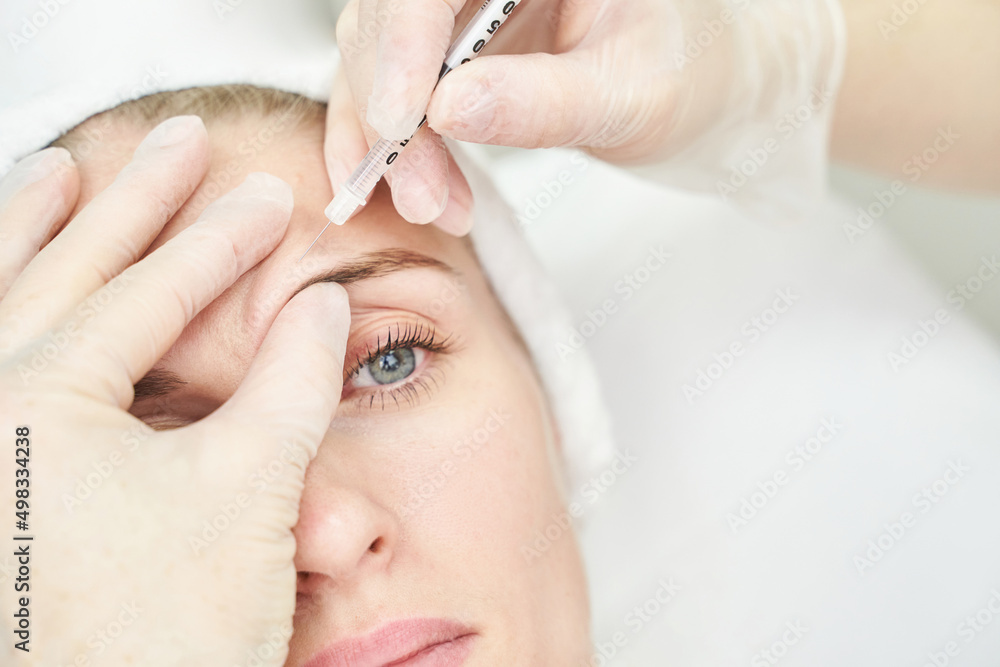© elenavolf - Injection at spa salon. Doctor hands in gloves. Closeup. Pretty female patient. Beauty treatment. Healthy skin procedure. Young women face. Plasmolifting rejuvenation