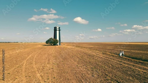 Khablovskiy lighthouse tower against blue sky, Kherson region, Ukraine. Aerial view from drone of lonely majestic tower among the endless expanses of steppe. Concept of architecture photo