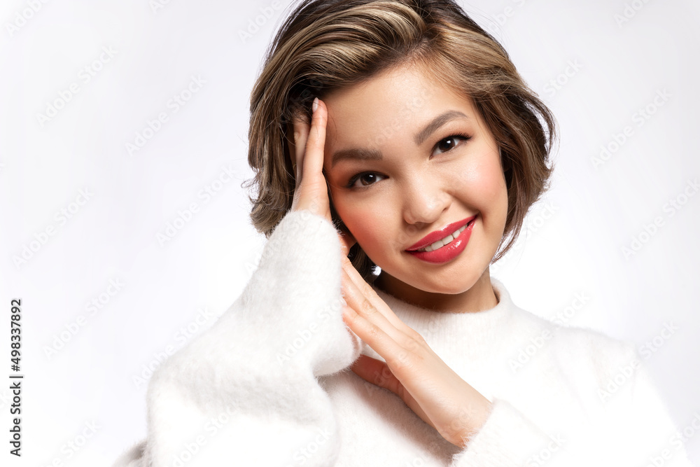 Stylish young asian woman with modern short haircut, ideal make up, glowing healthy skin advertising skin care moisturizing products, makeup cosmetics, posing on white studio background.