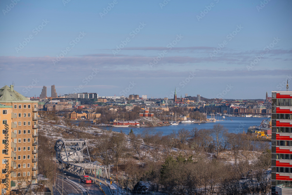 Panorama view over the Stockholm down town bays with castle, amusement park, boats and apartment houses a snowy spring day in Stockholm