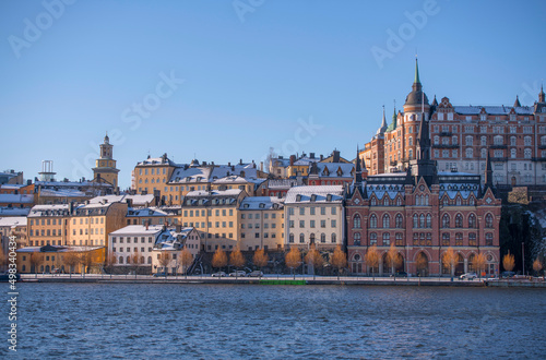 Block with old 1700s houses a snowy spring day in Stockholm photo