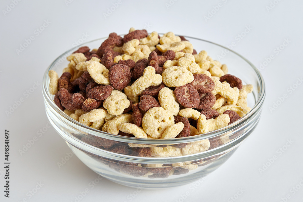 Granola in a transparent bowl on a white background. Healthy food. Baby food. Granola in a transparent bowl on a white background. Healthy food. Baby food.
