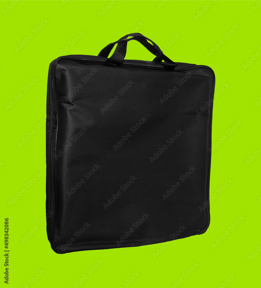 Naklejka premium a simple bag made of material, black, for a laptop, on a light green background