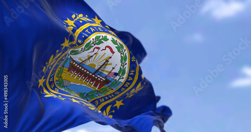 The US state flag of New Hampshire waving in the wind photo