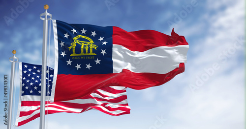 Fotografie The Georgia state flag waving along with the national flag of the United States