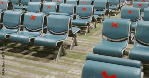 Empty rows of airport seats marked with red signs crosses for distance, no people, departure lounge, waiting room. Social distancing on transport due to COVID-19 pandemic photo