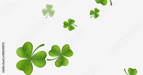 Animation of multiple clover leaves falling on white background photo