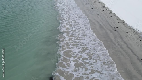 Flight alongside sea shore / blue sea and whight sandy beach 