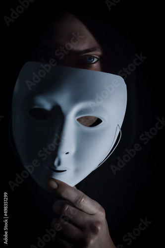 Take off the mask - Portrait of a young hooded man who takes off his mask, letting his gaze be seen, concept for being true and authentic